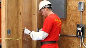 Electrician working on a wall installation