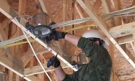 Technician installing lighting wiring